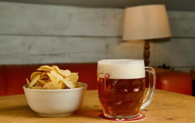 Two Pints Of Lager & A Packet Of Crisps Please
